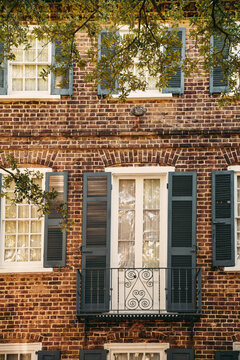 Classic Brick Row House With Navy Shutters