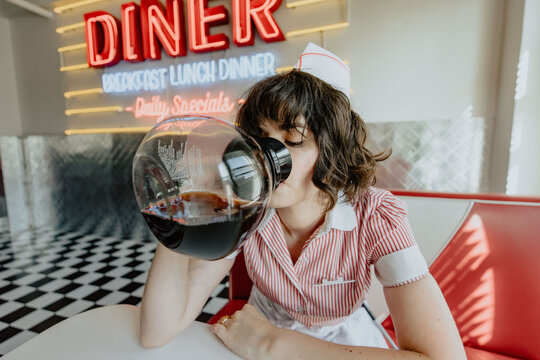 1950s Diner Waitress Drinking From Coffeepot 