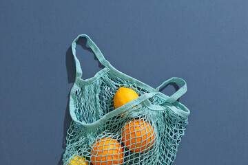 Fresh mandarines in a string bag, eco-friendly product