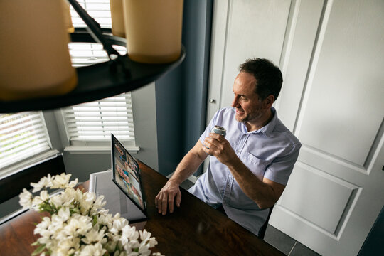 Distancing: Man Hangs Out With Friends During Virtual Happy Hour