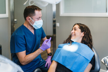 Patient and dentist laughing