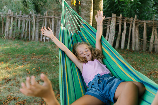 Young girls swinging in a hammock 