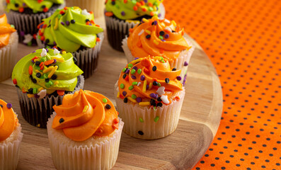 Halloween Cupcakes with Sprinkles on an Orange and Black Tablecloth
