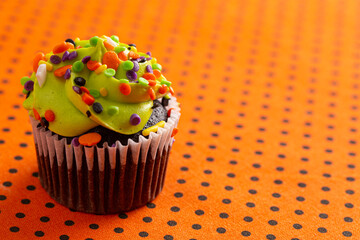 Halloween Cupcakes with Sprinkles on an Orange and Black Tablecloth