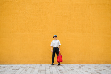 Fashion Asian man  standing at street wall