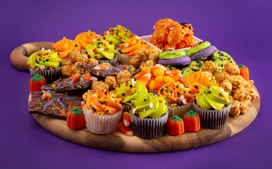 Halloween Themed Charcuterie Board on a Dark Purple Background