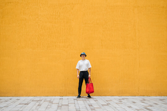Fashion Asian man  standing at street wall