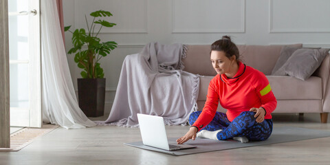 Vertical photo of a middle aged woman prepares for online workout. Format photo 2x1.