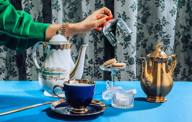 Stylish female hands at tea time/party