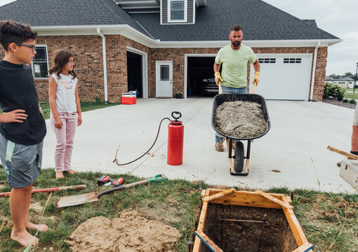 Father working while kids watch. 