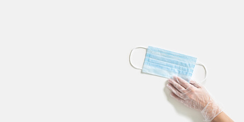 Woman hand take medical mask for protection from virus and bacteria. Coronavirus prevention medical surgical mask