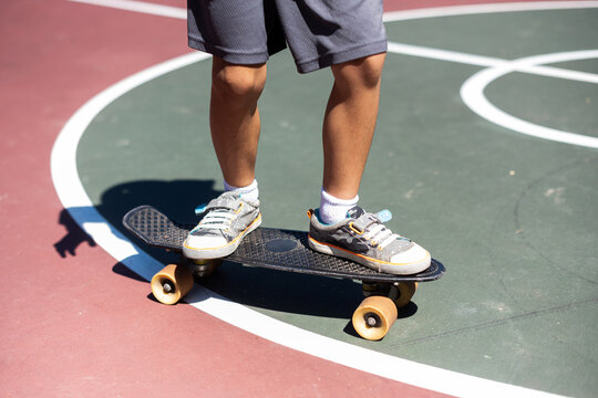 Child learning to ride skateboard