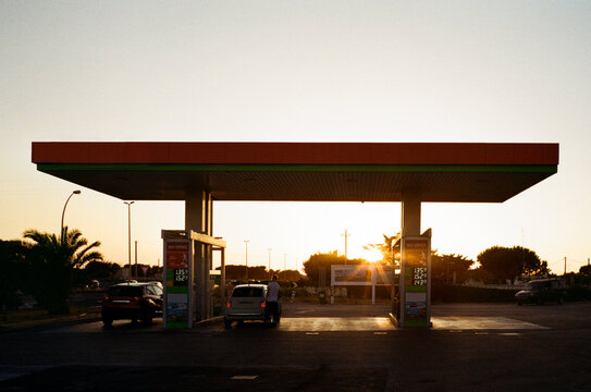 A minimalist petrol station during the sunset