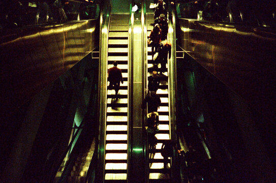 Anonymous people using the escalator 