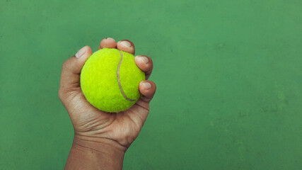 tennis ball in hand