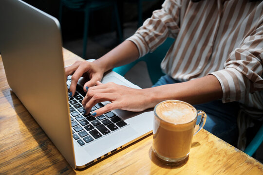 Woman typing on her laptop