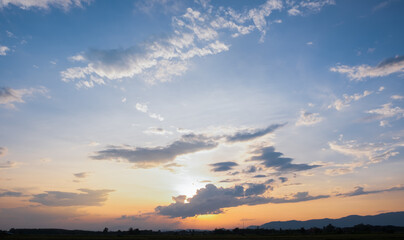Colorful sunset and sunrise with clouds.Blue and orange color of nature.Many white clouds in the blue sky.The weather is clear today.sunset in the clouds.The sky is twilight.