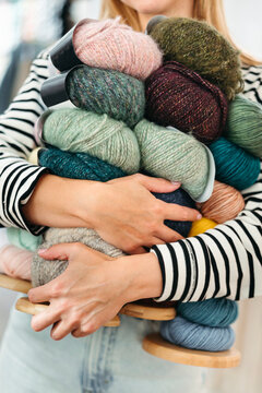 An anonymous female knitter with yarn in her hands.