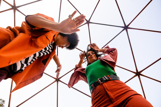 Interracial couple street dancing in a dome