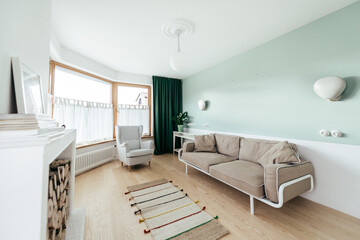 Living room with a brown couch, arm chair and chimney 