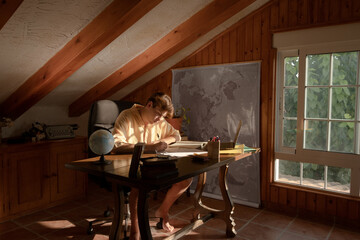 Pensive student sitting writting