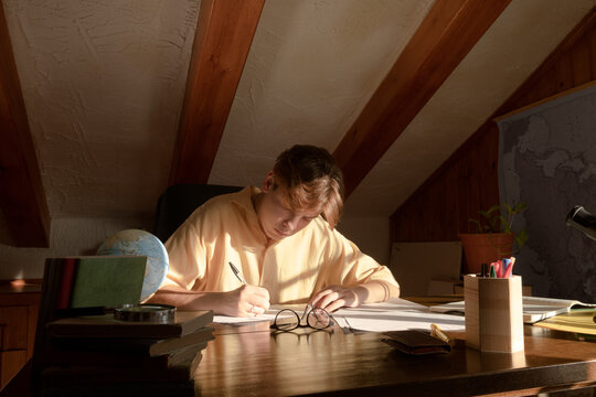 Pensive student sitting writting