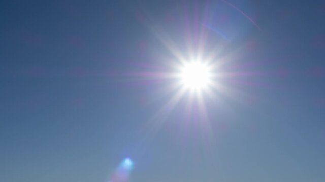 timelapse of beautiful sun star in blue sky. slow moving sun in clear atmosphere. solar energy of summer sun rays, sunbeams. bright peaceful color in heaven. sunlight in hot weather nature footage