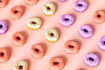 Pattern od colorful donuts on pink background