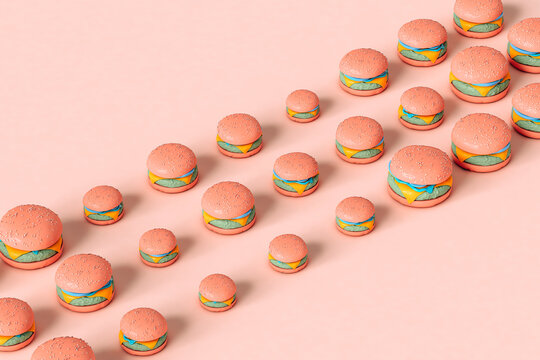 pink cheeseburgers in different sizes on pink 
