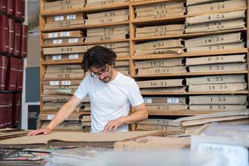 Man Reading Periodical In Archive