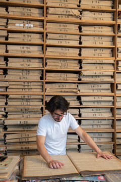 Person Reading Old Newspaper In Archive