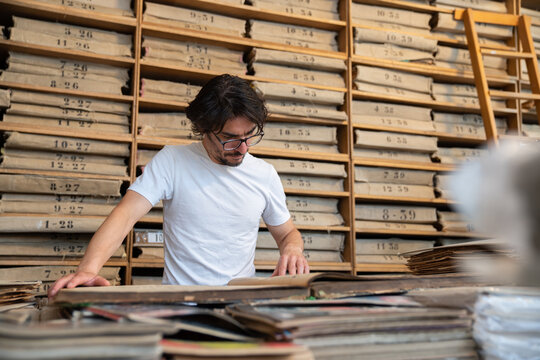 Man Reading  Old Press In Archive