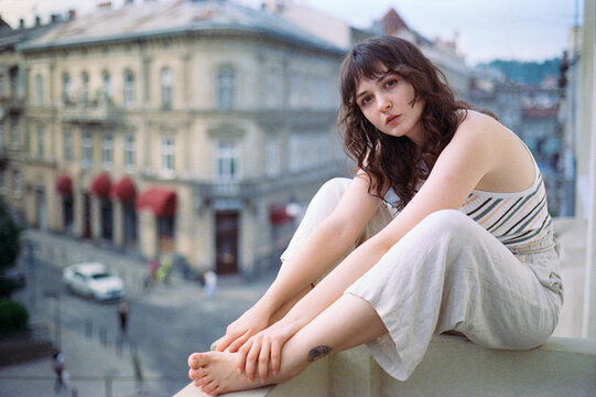 Portrait of woman sitting on the balcony 