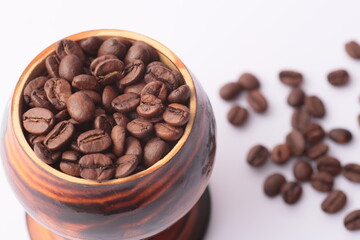 coffee beans and a cup on a white background