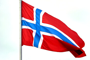 The flag of Norway hangs on the flagpole