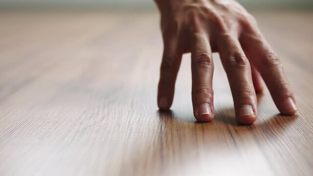 Close up hand of woman dragging on clean wooden laminate floor, Slow motion, Fashionable living.