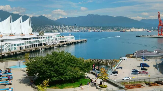 People At The Promenade Near Canada Place In Vancouver With Seabus Cruising Across Burrard Inlet. hyperlapse, zoom-out