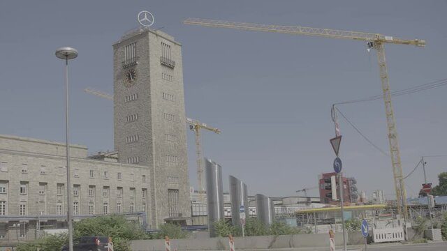 Camera pans to the main entrance of Stuttgart's main train station, cars drive by.