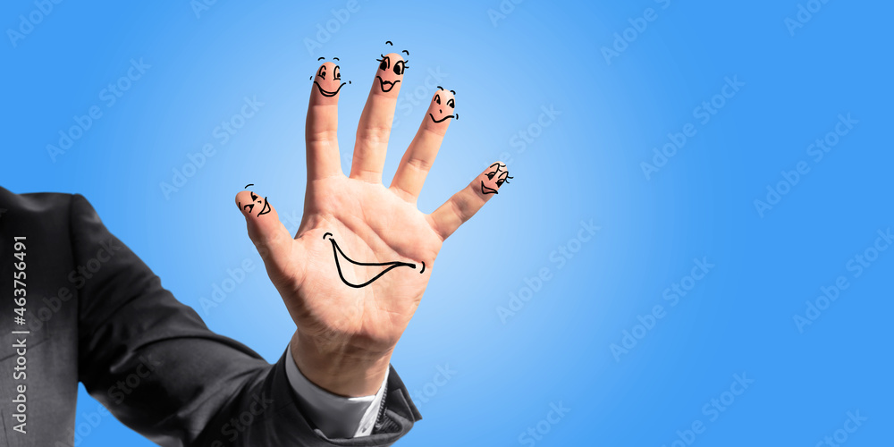 Poster close up of businessman hand with drawn smileys on blue background with mock up place. creativity an