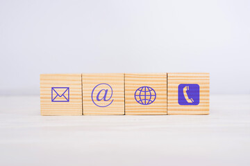 Wooden block cube symbol telephone, email, address.