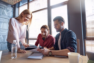 Business team working together at desk in office