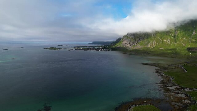 Drone flying next to mountains and road in Lofoten, Norway