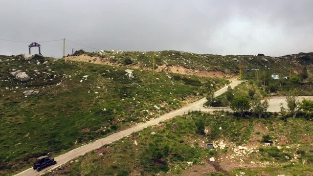 Buggy Vehicle Driving At The Rural Road On The Rugged Mountain In Lebanon. aerial