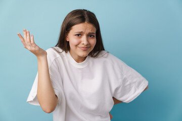 Young white brunette woman frowning and holding copyspace