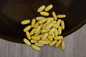 yellow pills on the table, top view. Medicine and healthcare