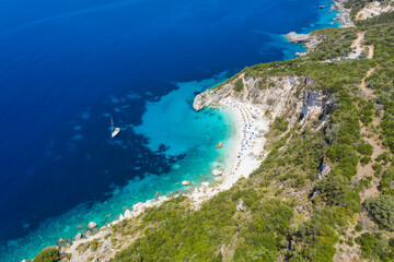 Fototapeta na wymiar Aerial drone photo of iconic paradise sandy beach of Agiofili near port of Vasiliki with emerald crystal clear sea and sail boats docked, Lefkada island, Ionian, Greece