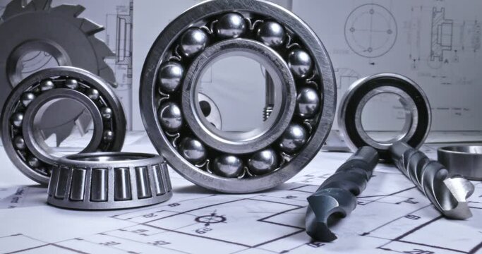 Mechanical diagrams, drill and bearings. Mechanical parts on designer desk.