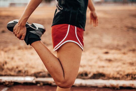 A beautiful woman stretching her body before running in the morning with a bright smile on her face. women's health care concept