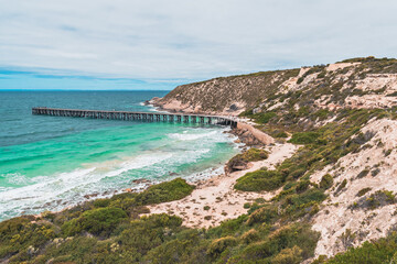Fototapeta na wymiar Stenhouse Bay Jetty with people viewed from the lookout at Inneston Park, Yorke Peninsula, South Australia