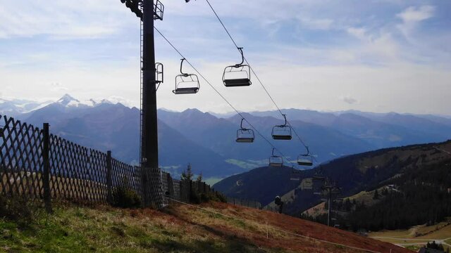 Ski Lift At Mount Schmitten And The Snowcapped Mountains Of Kitzbuhel In Salzburg, Austria. aerial